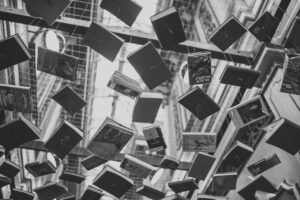 Libros colgando de cuerdas en el techo - foto en blanco y negro