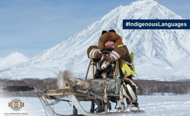 Hombre esquimal sobre un trineo rodeado de nieve