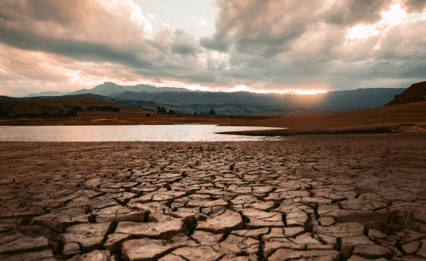 Suelo cuartedo por la sequía bajo un cielo nuboso en el atardecer