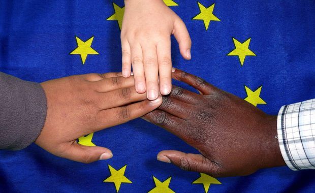 manos sobre la bandera de Europa